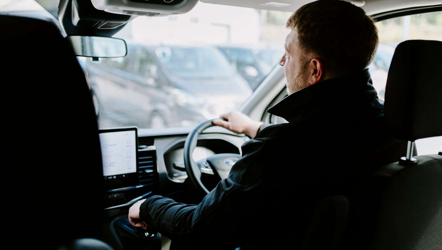 U-Drive team member driving and ev